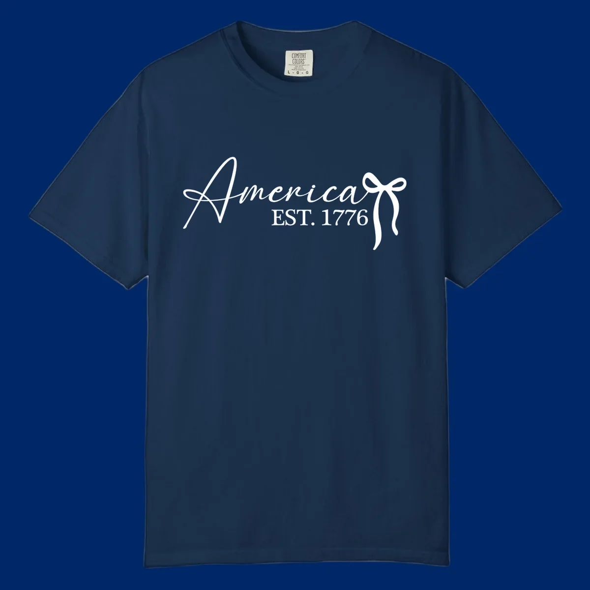 White script text "America" with decorative flourishes above "EST. 1776" in serif font, on a black background. Design for america-est-1776.