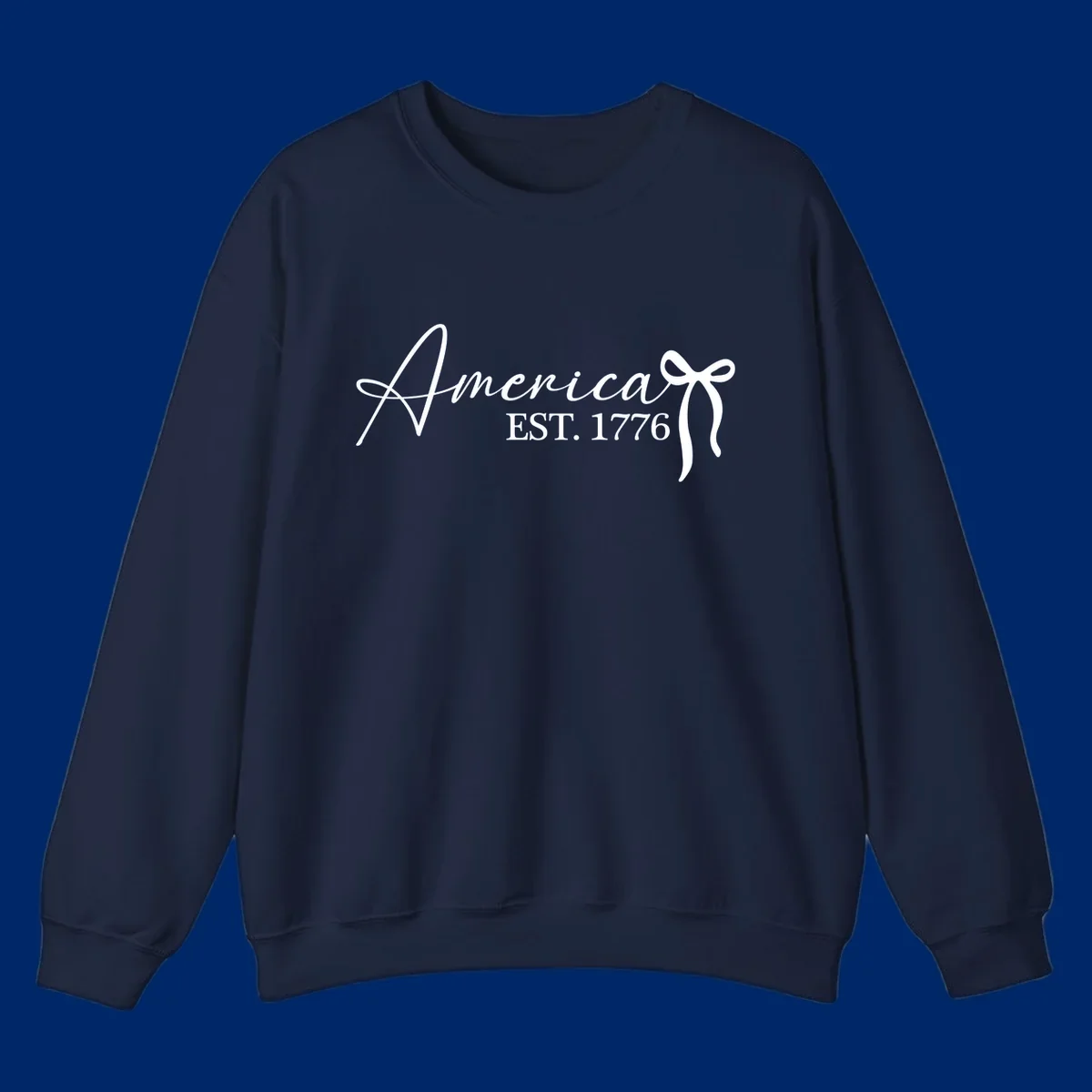 White script text "America" with decorative flourishes above "EST. 1776" in serif font, on a black background. Design for america-est-1776.