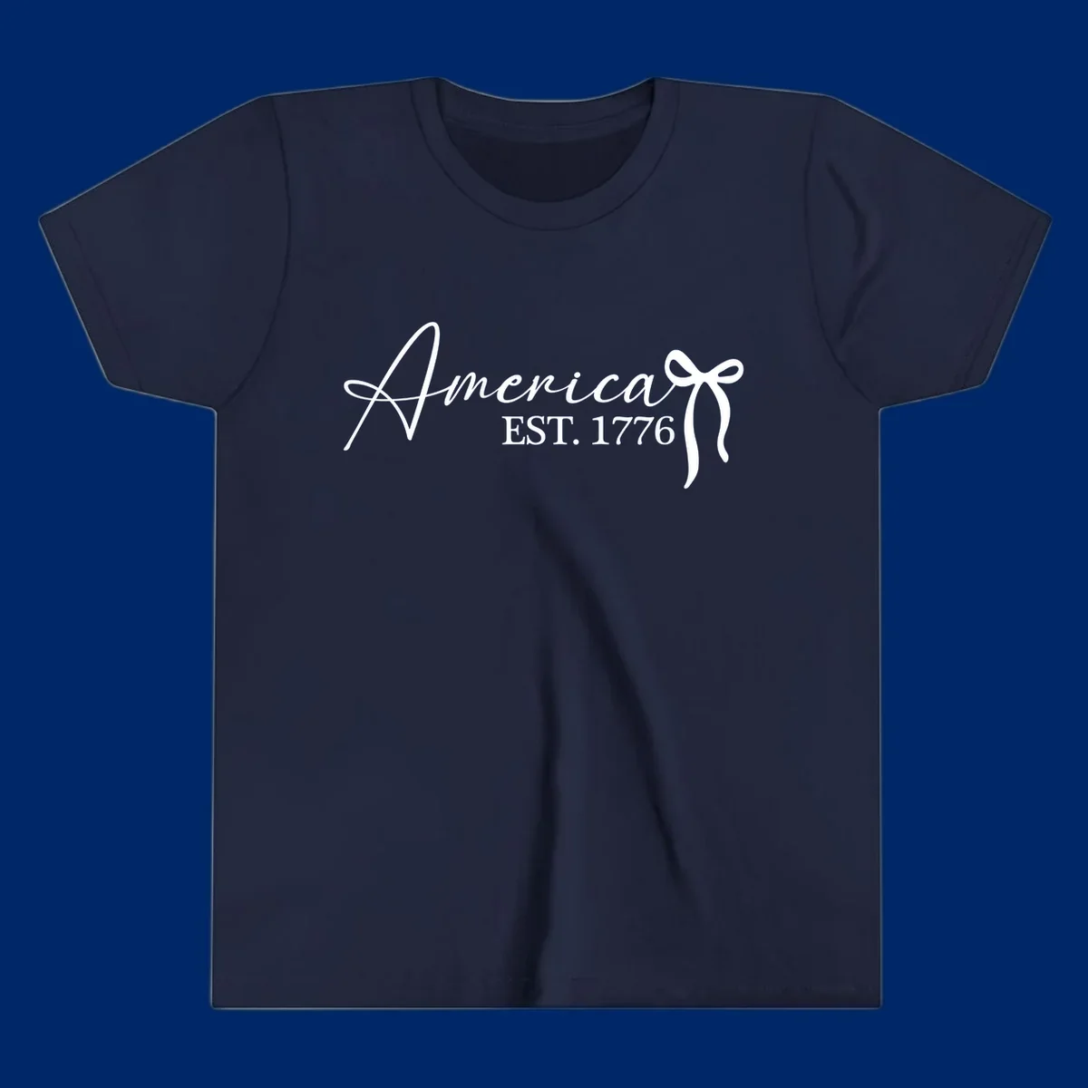 White script text "America" with decorative flourishes above "EST. 1776" in serif font, on a black background. Design for america-est-1776.