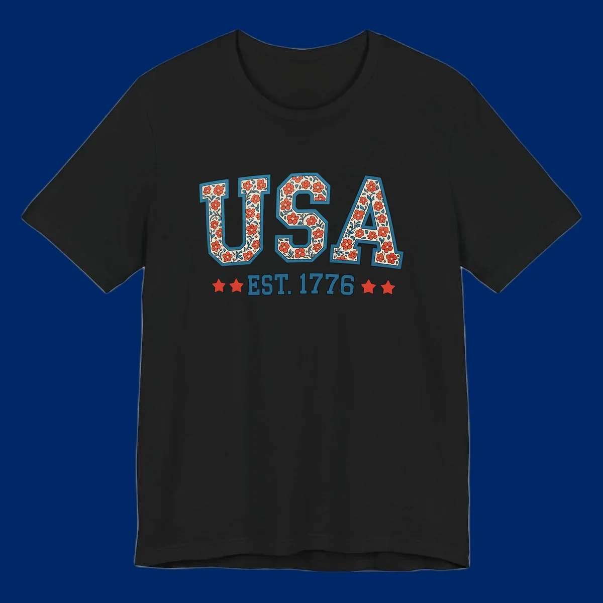Illustrated text 'USA' with red flowers and blue leaves, above blue 'EST. 1776' text flanked by red stars. Concept: usa-est-1776-floral.