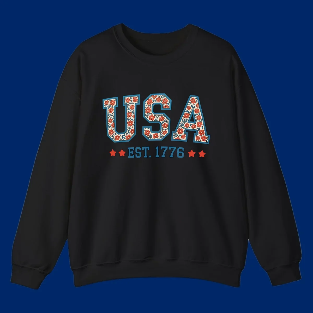 Illustrated text 'USA' with red flowers and blue leaves, above blue 'EST. 1776' text flanked by red stars. Concept: usa-est-1776-floral.