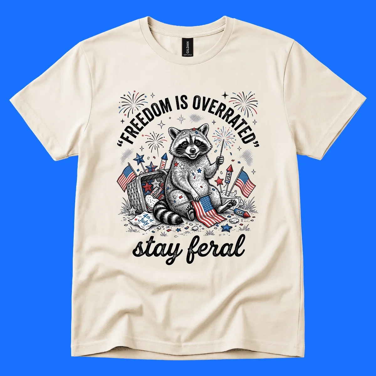 A black and white illustration of a feral raccoon celebrating July 4th with fireworks, American flags, and the text 'FREEDOM IS OVERRATED' and 'stay feral'.