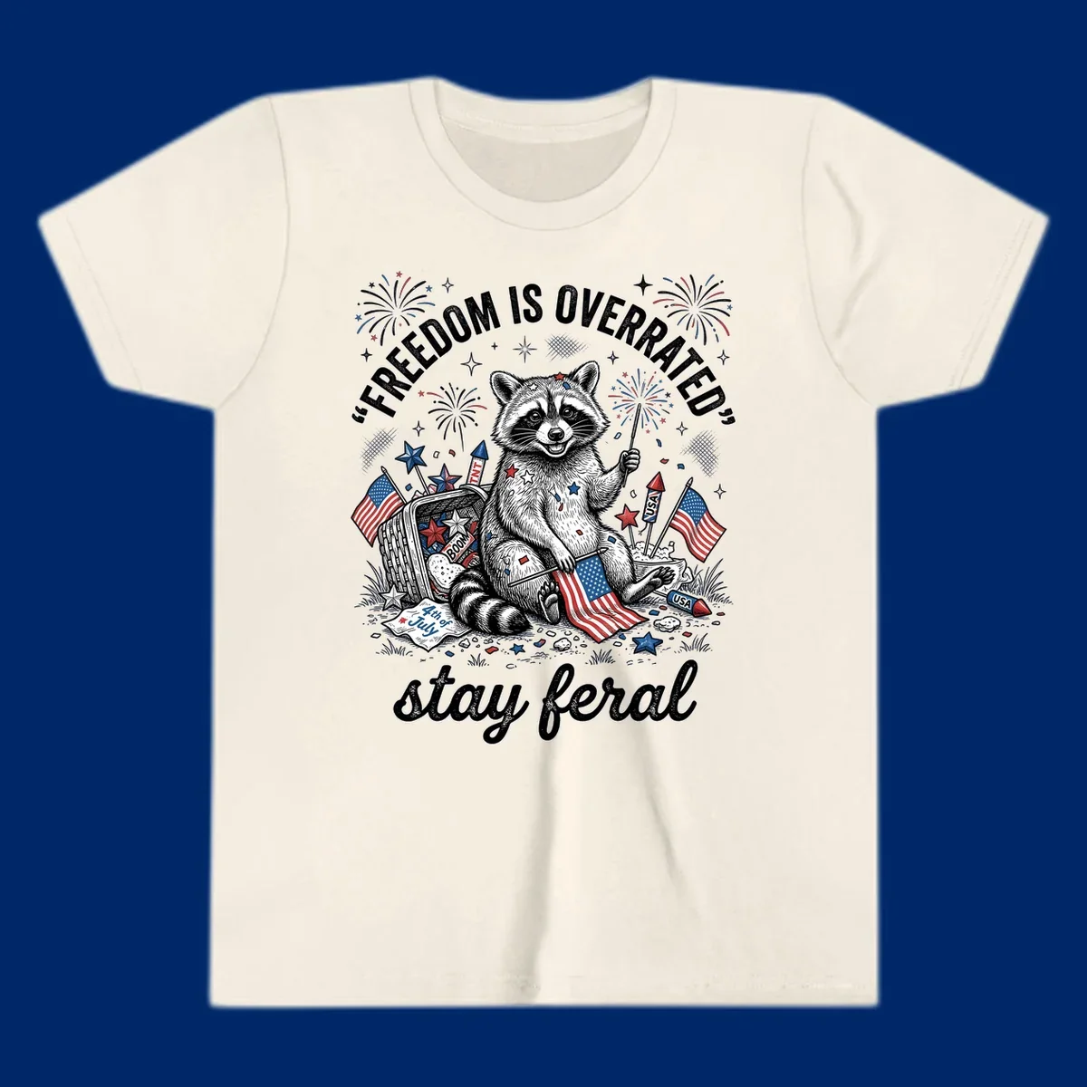 A black and white illustration of a feral raccoon celebrating July 4th with fireworks, American flags, and the text 'FREEDOM IS OVERRATED' and 'stay feral'.