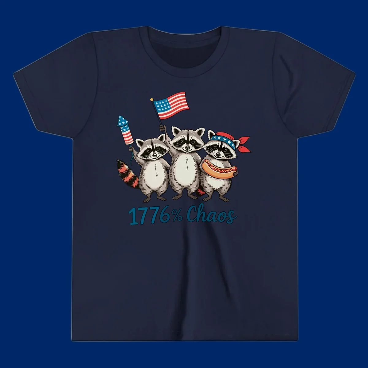 Illustration of three patriotic raccoons celebrating with an American flag, firework, and hot dog, with '1776% Chaos' text. Represents 1776-chaos-raccoons-celebration.
