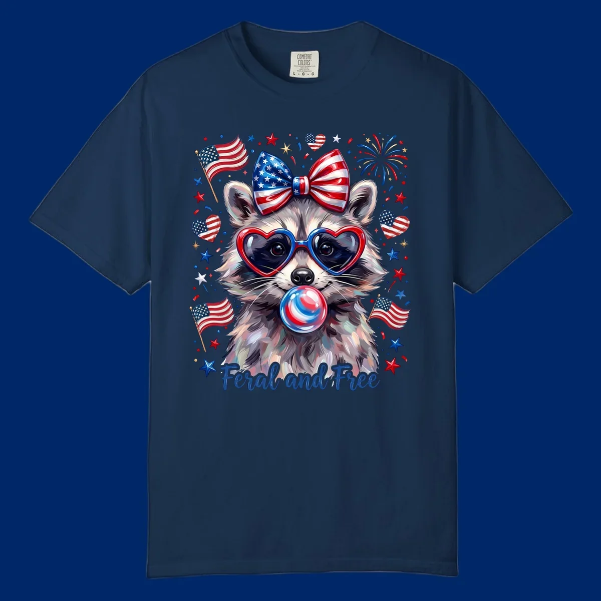 Watercolor illustration of a patriotic raccoon wearing heart sunglasses, blowing bubblegum, with American flags, fireworks, and 'Feral and Free' text for a patriotic-raccoon-july-4th celebration.