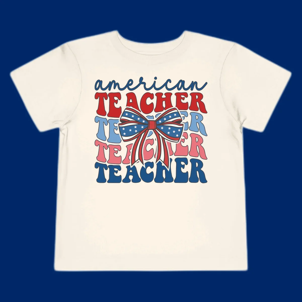 A graphic design reading 'american TEACHER' with the word TEACHER repeated four times, featuring a large patriotic American flag bow with stars and stripes. The text is in red, blue, and pink colors, outlined in dark gray.