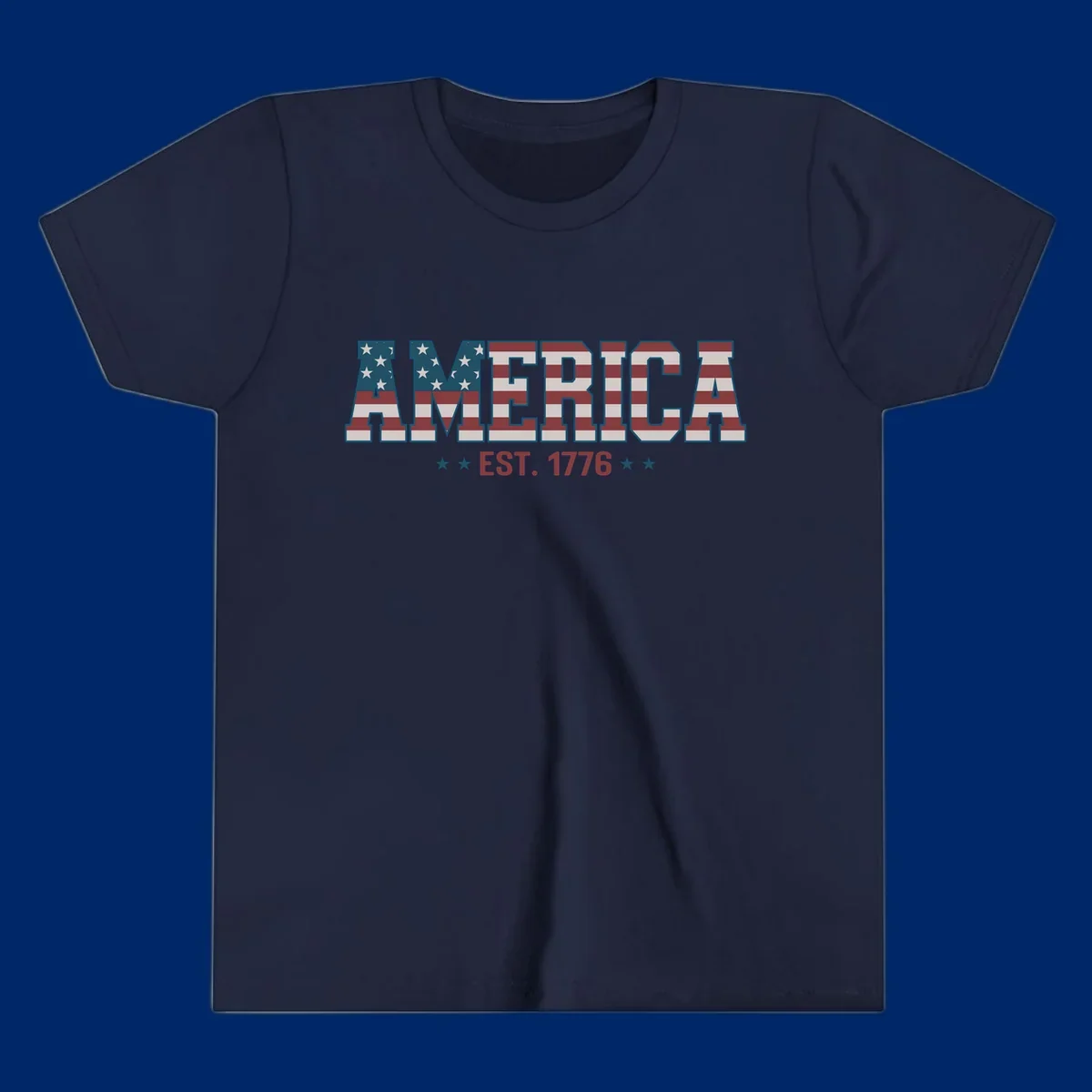 The word AMERICA in large block letters filled with a distressed American flag pattern, with EST. 1776 below flanked by stars, representing america-established-1776.