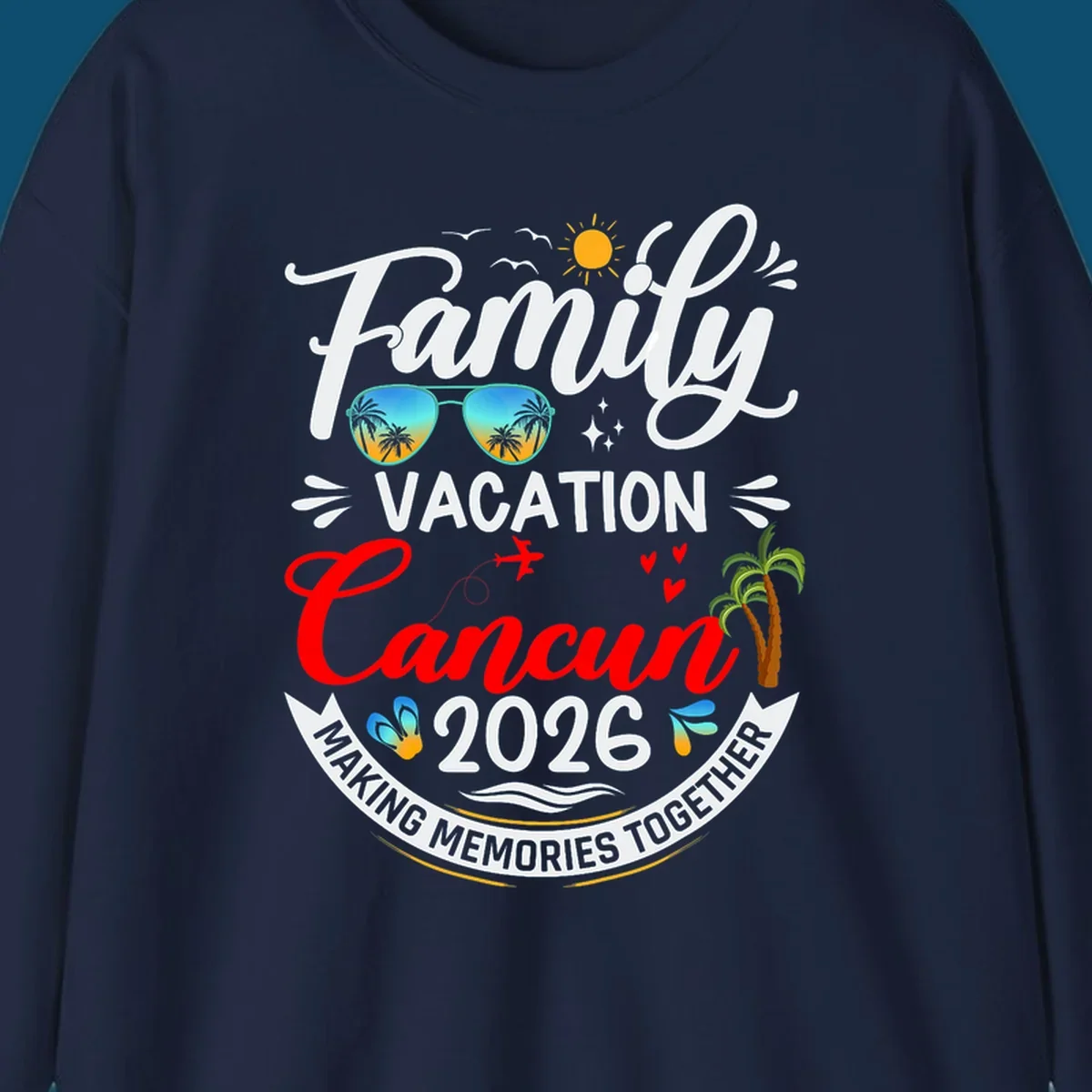 A vibrant "Family Cancun Vacation 2026" t-shirt design with a sun, birds, sunglasses, airplane, hearts, and palm trees.