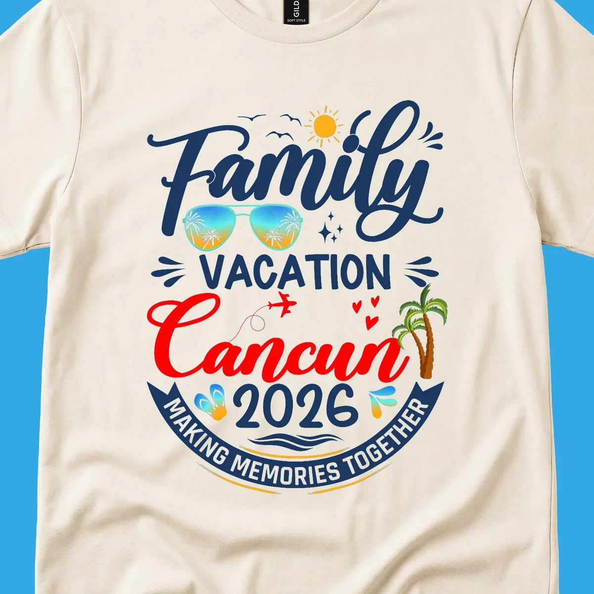 A vibrant "Family Cancun Vacation 2026" t-shirt design with a sun, birds, sunglasses, airplane, hearts, and palm trees.