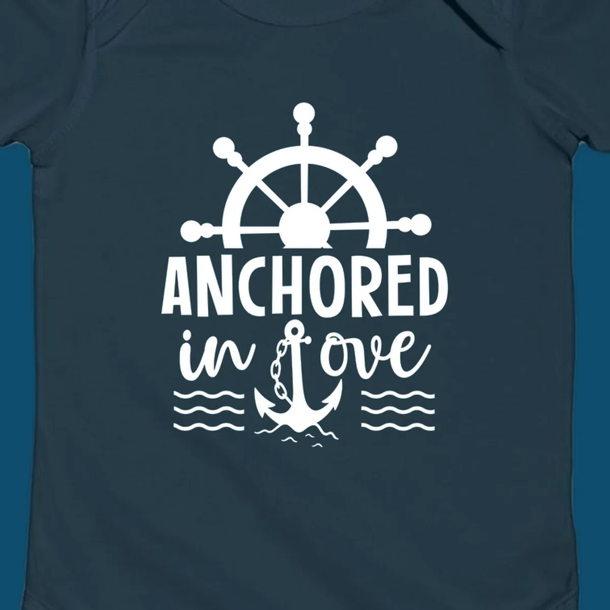 A 'Anchored in love cruise' design with a ship's wheel, the text ANCHORED in love, an anchor, and ocean waves.