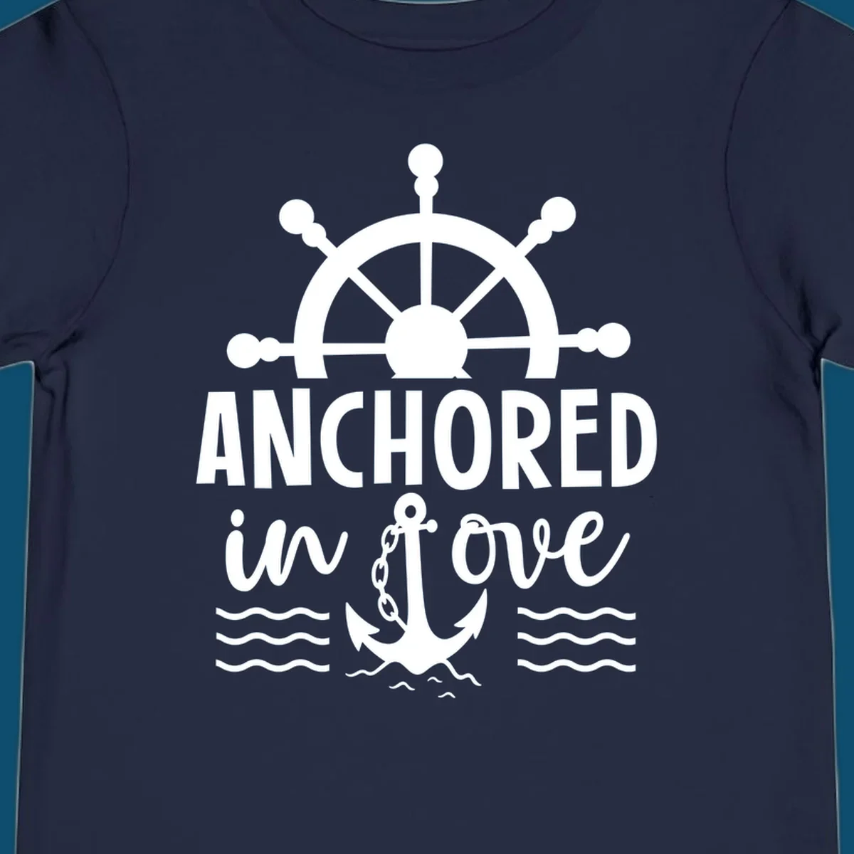 A 'Anchored in love cruise' design with a ship's wheel, the text ANCHORED in love, an anchor, and ocean waves.