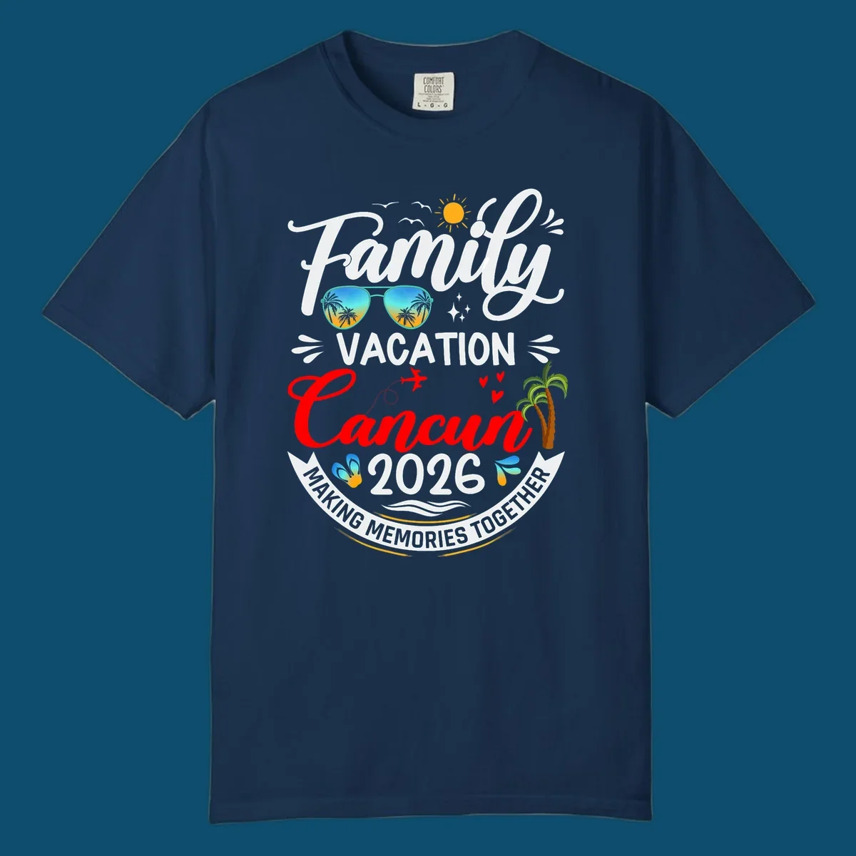 A vibrant "Family Cancun Vacation 2026" t-shirt design with a sun, birds, sunglasses, airplane, hearts, and palm trees.