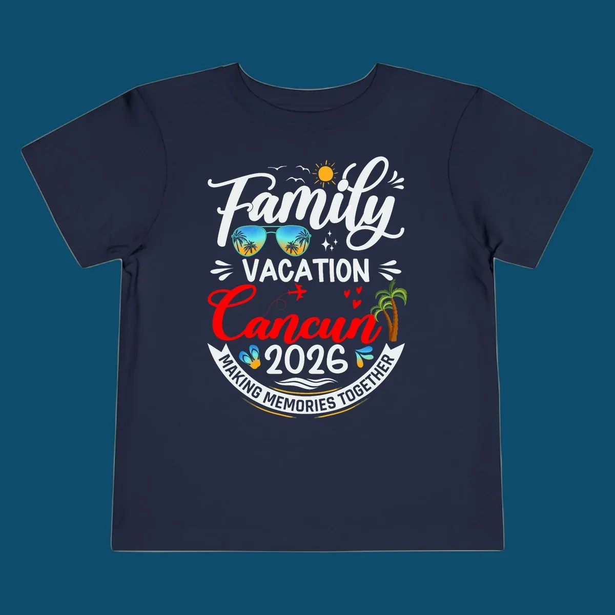 A vibrant "Family Cancun Vacation 2026" t-shirt design with a sun, birds, sunglasses, airplane, hearts, and palm trees.