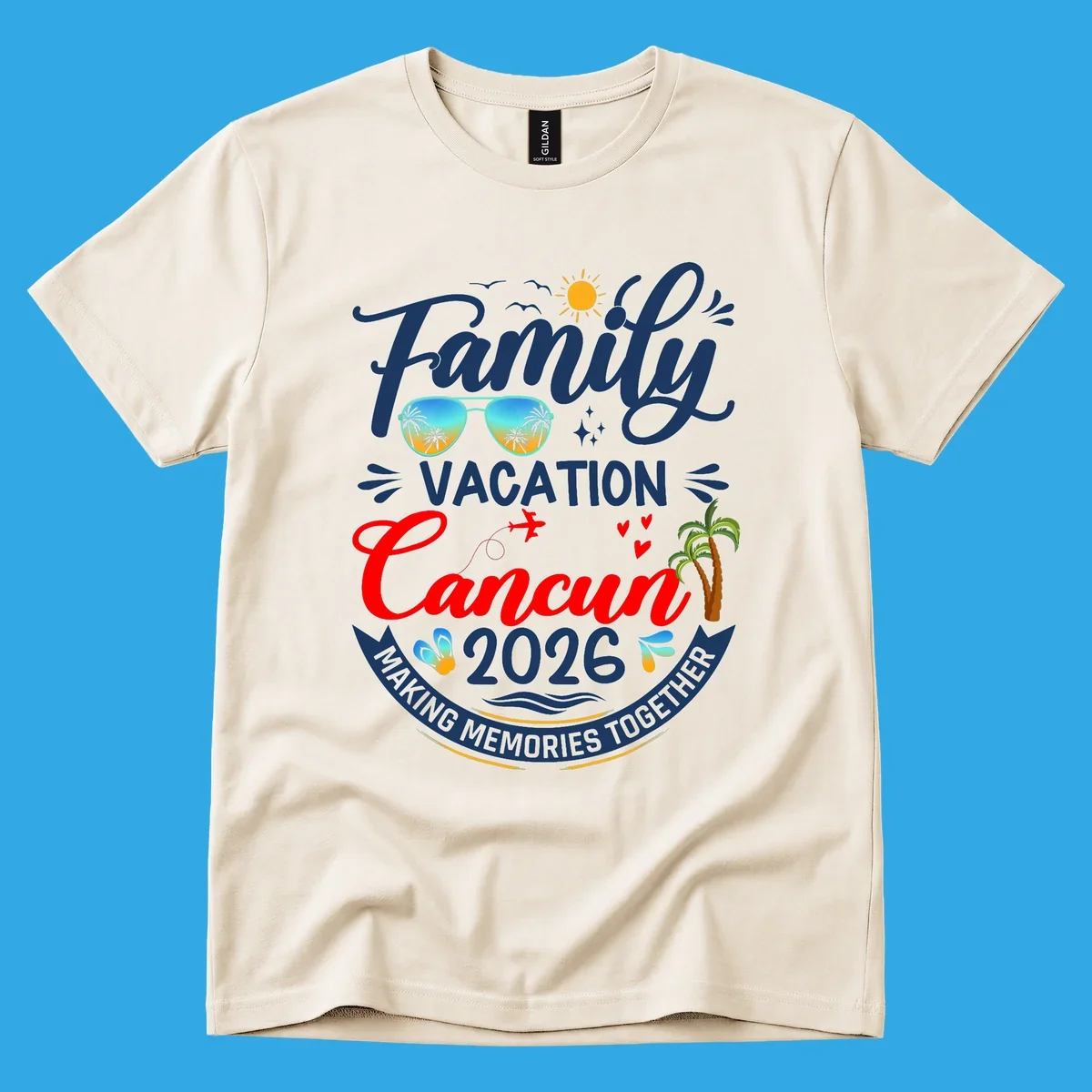 A vibrant "Family Cancun Vacation 2026" t-shirt design with a sun, birds, sunglasses, airplane, hearts, and palm trees.