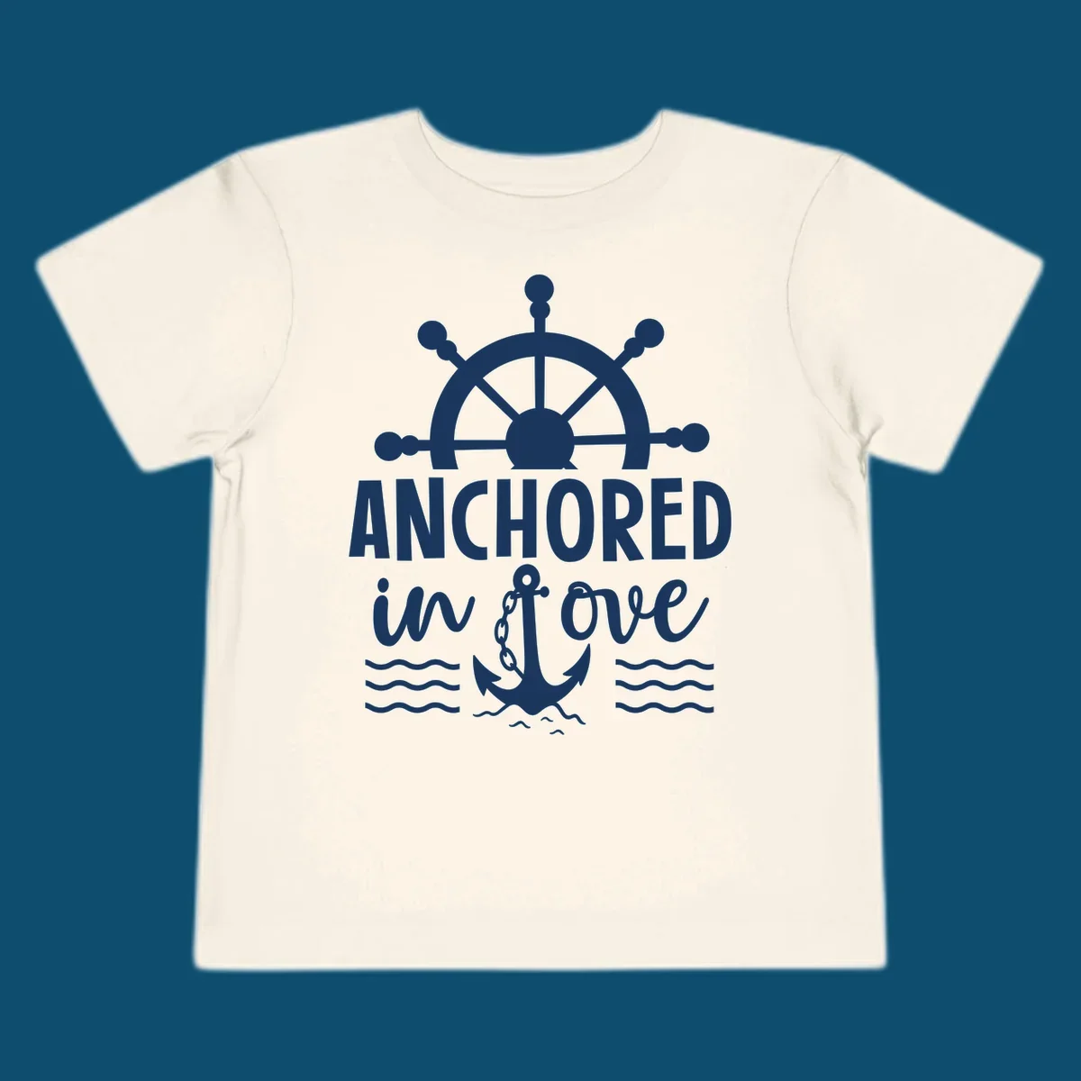 A graphic featuring a ship wheel above the text 'ANCHORED in love' with an anchor and waves below, ideal for an anchored-in-love-cruise.