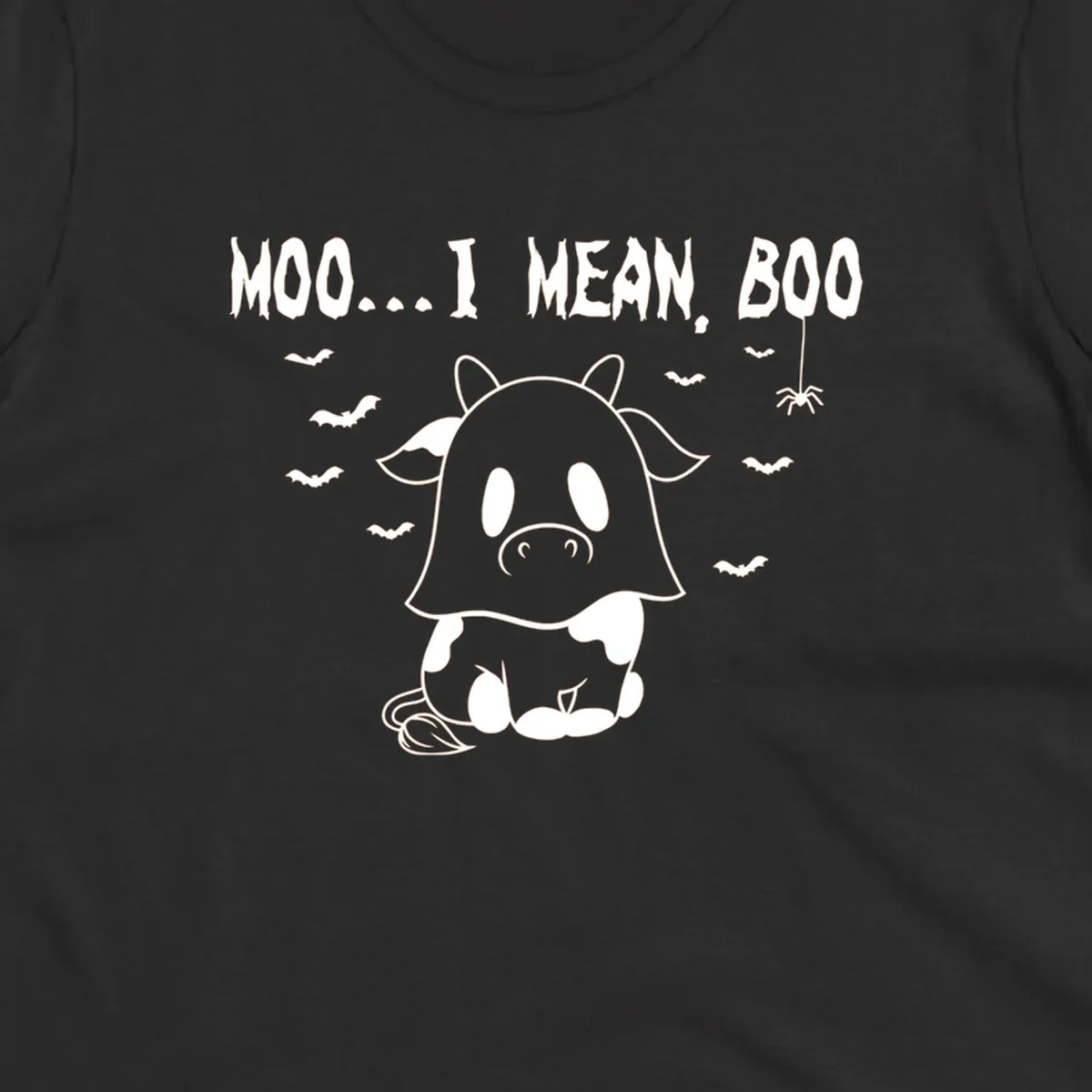 Illustration of a cow dressed as a ghost saying Moo... I mean, Boo, with bats and a spider. Moo-boo-cow.