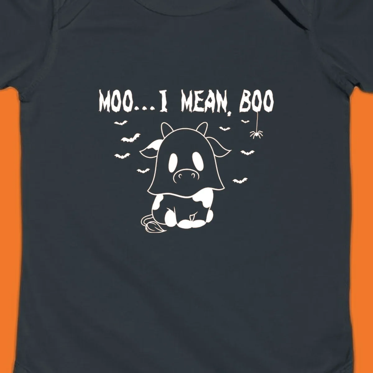 Illustration of a cow dressed as a ghost saying Moo... I mean, Boo, with bats and a spider. Moo-boo-cow.