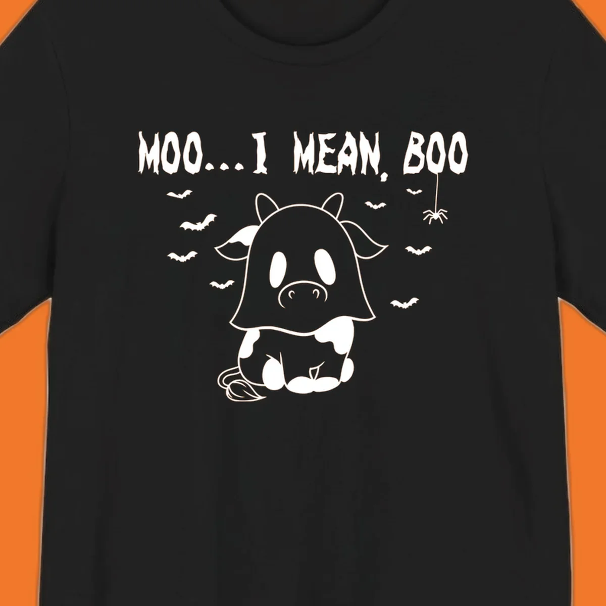 Illustration of a cow dressed as a ghost saying Moo... I mean, Boo, with bats and a spider. Moo-boo-cow.