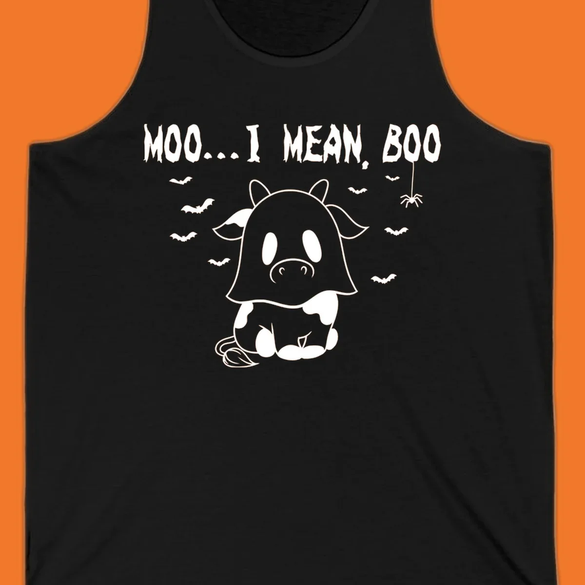 Illustration of a cow dressed as a ghost saying Moo... I mean, Boo, with bats and a spider. Moo-boo-cow.