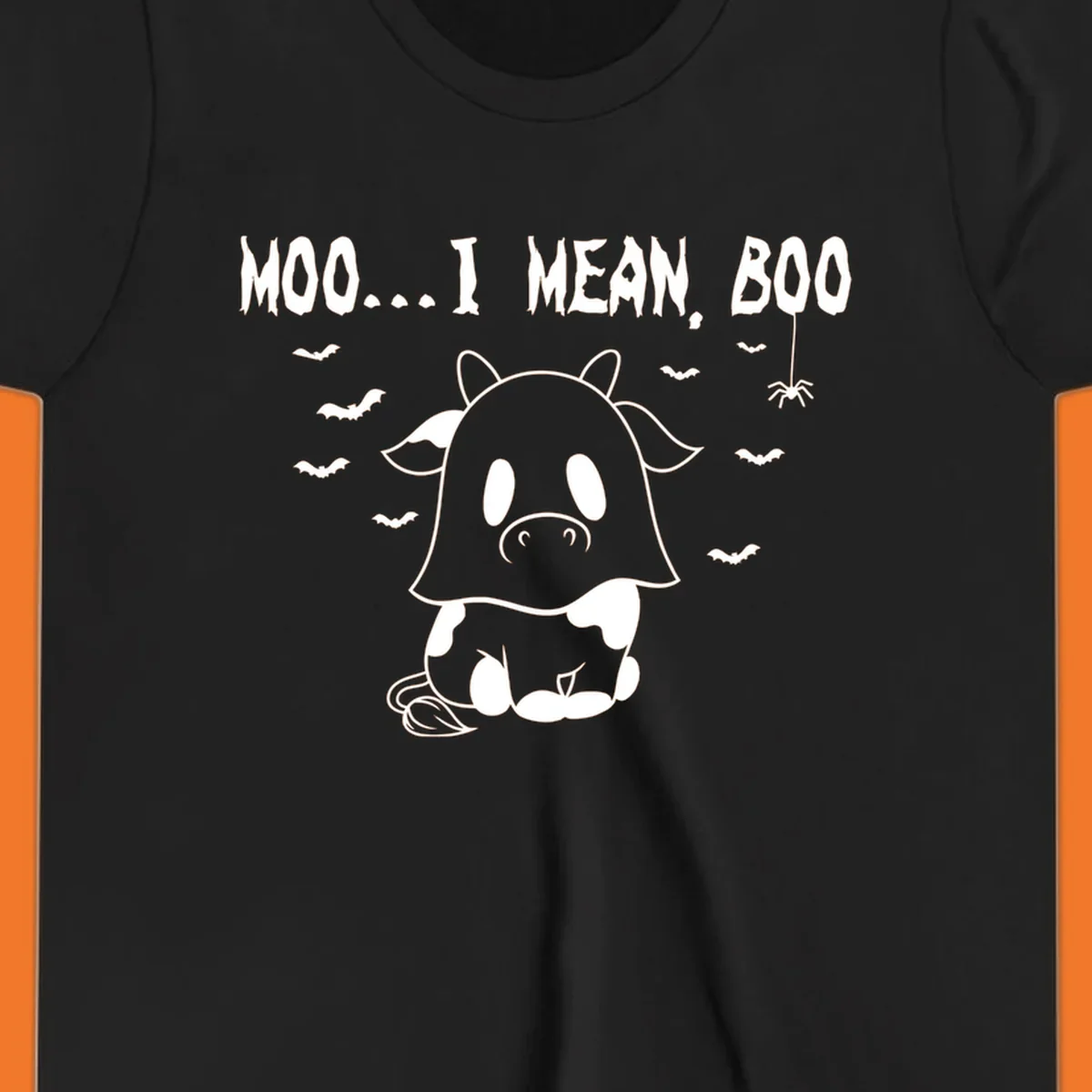 Illustration of a cow dressed as a ghost saying Moo... I mean, Boo, with bats and a spider. Moo-boo-cow.