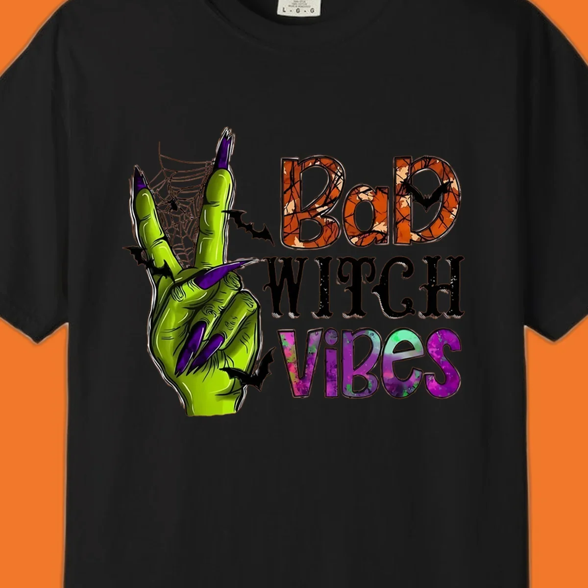 Bad Witch Vibes Halloween graphic with a green witch hand peace sign and bats.