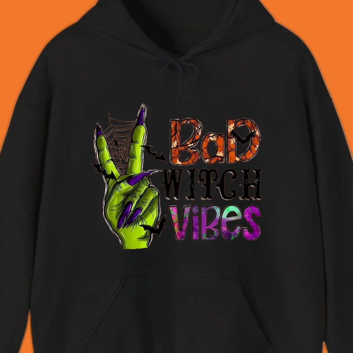 Bad Witch Vibes Halloween graphic with a green witch hand peace sign and bats.