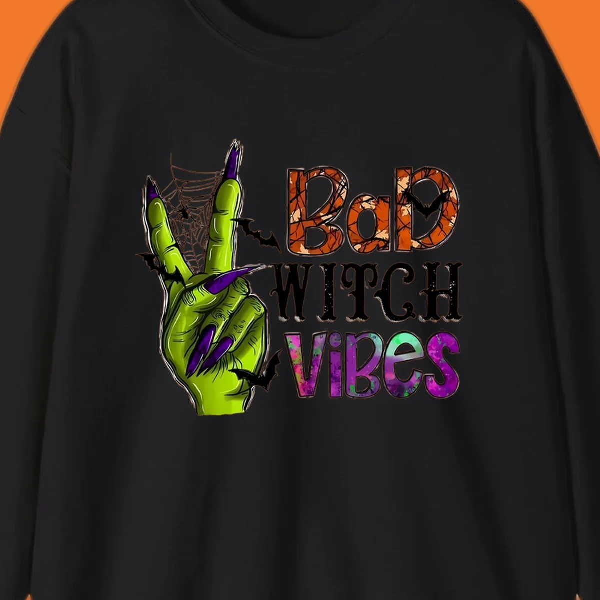 Bad Witch Vibes Halloween graphic with a green witch hand peace sign and bats.