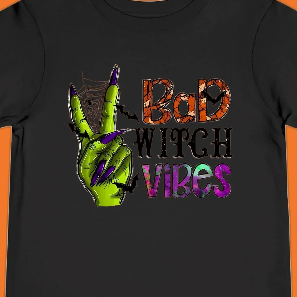 Bad Witch Vibes Halloween graphic with a green witch hand peace sign and bats.