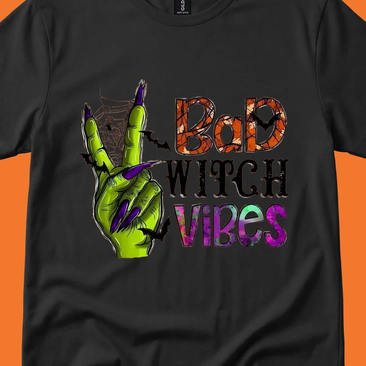 Bad Witch Vibes Halloween graphic with a green witch hand peace sign and bats.