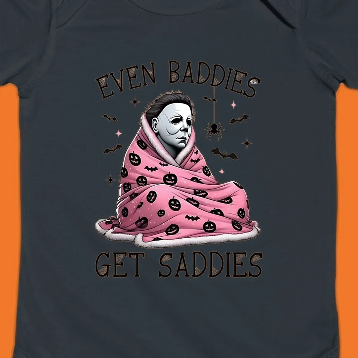 Michael Myers in a pink pumpkin blanket with text 'EVEN BADDIES GET SADDIES', for the michael-myers-cozy concept.
