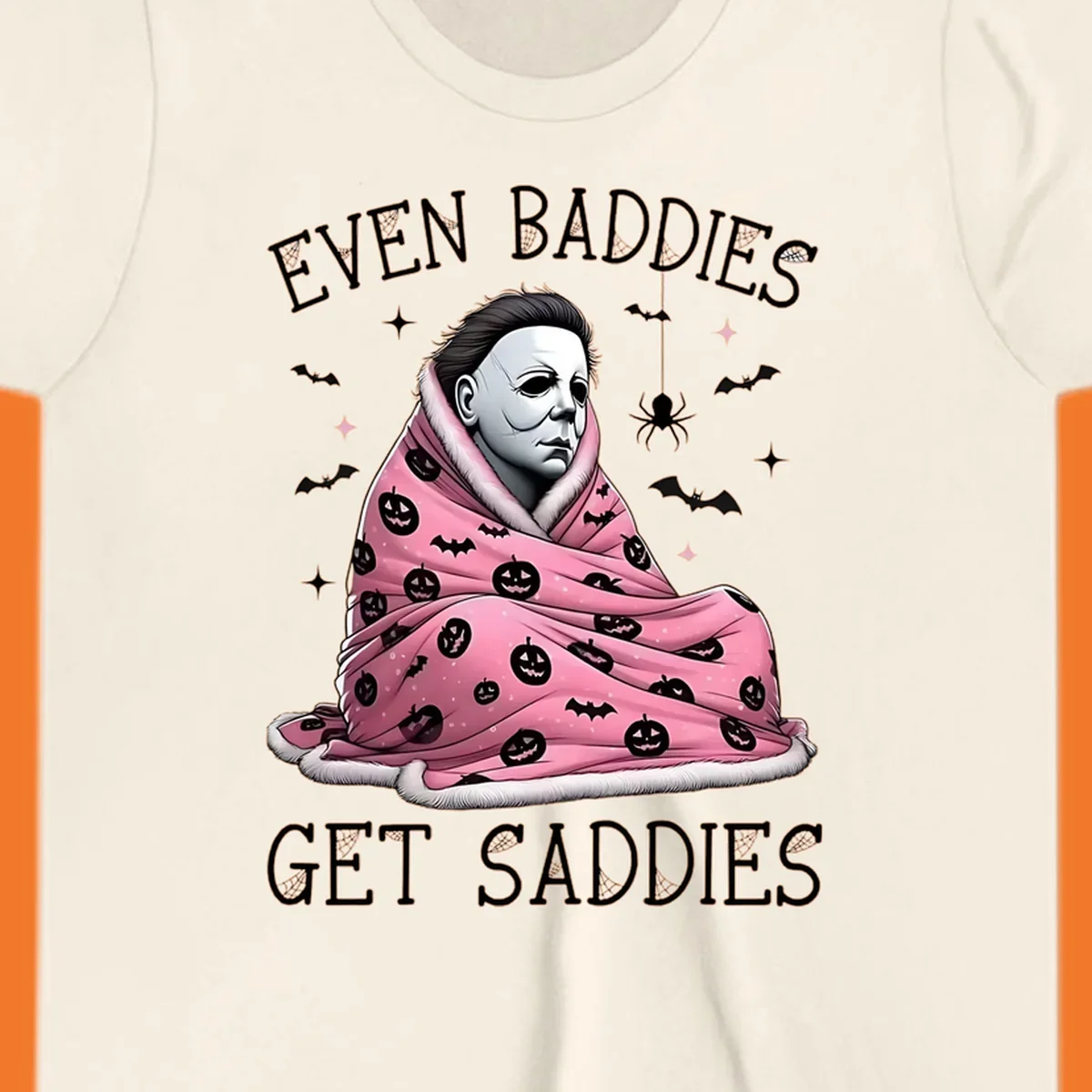 Michael Myers in a pink pumpkin blanket with text 'EVEN BADDIES GET SADDIES', for the michael-myers-cozy concept.