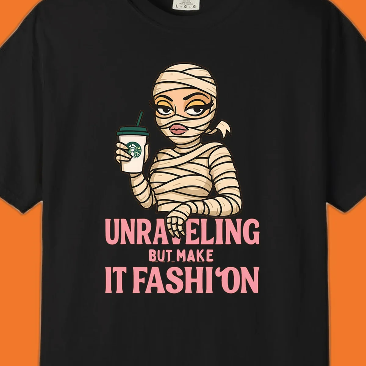 Mummy holding coffee cup with 'Unraveling But Make It Fashion' text. Mummy-fashion-coffee.