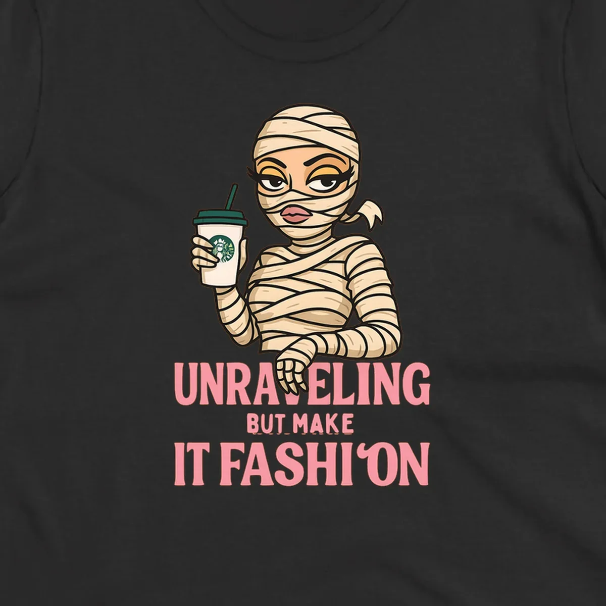 Mummy holding coffee cup with 'Unraveling But Make It Fashion' text. Mummy-fashion-coffee.