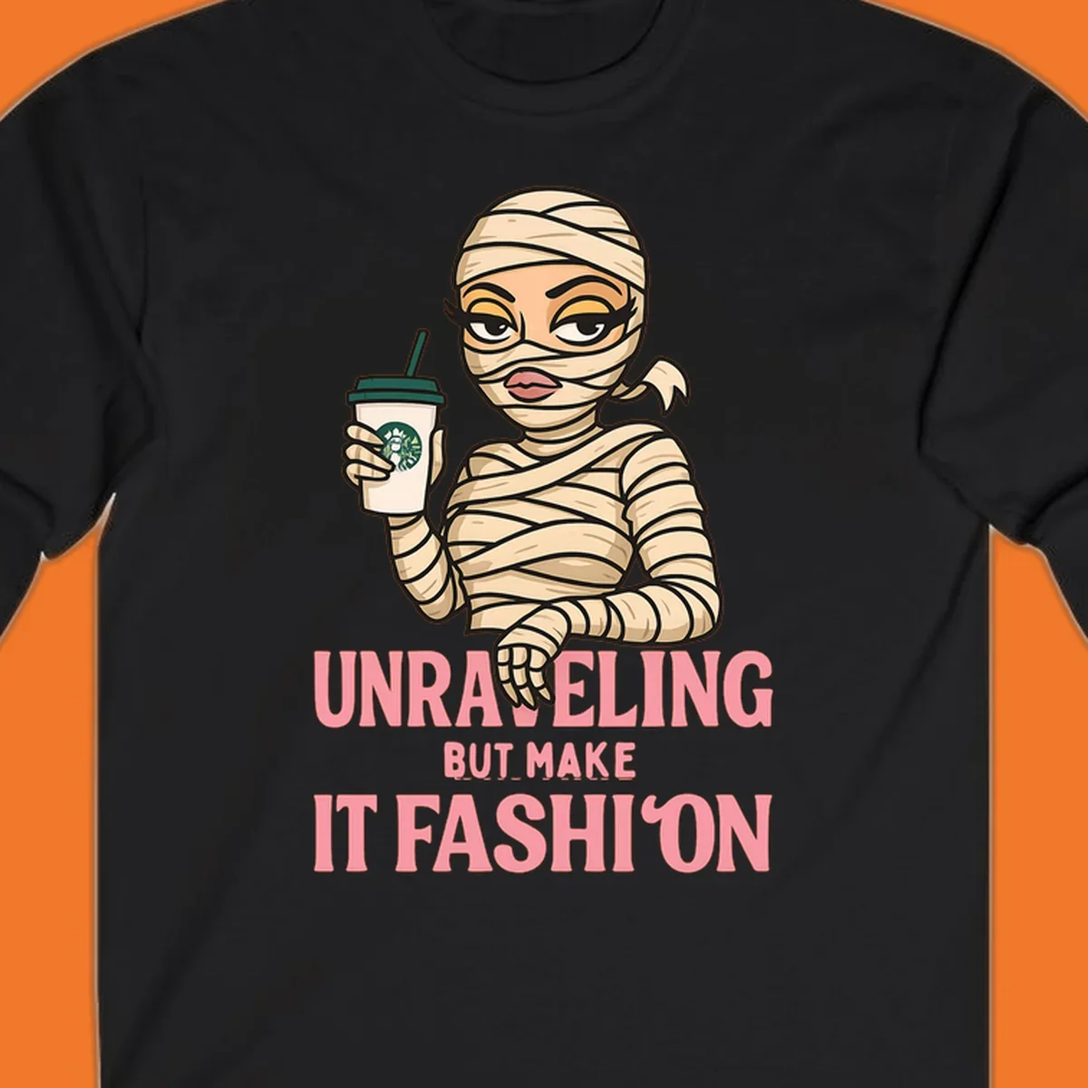Mummy holding coffee cup with 'Unraveling But Make It Fashion' text. Mummy-fashion-coffee.