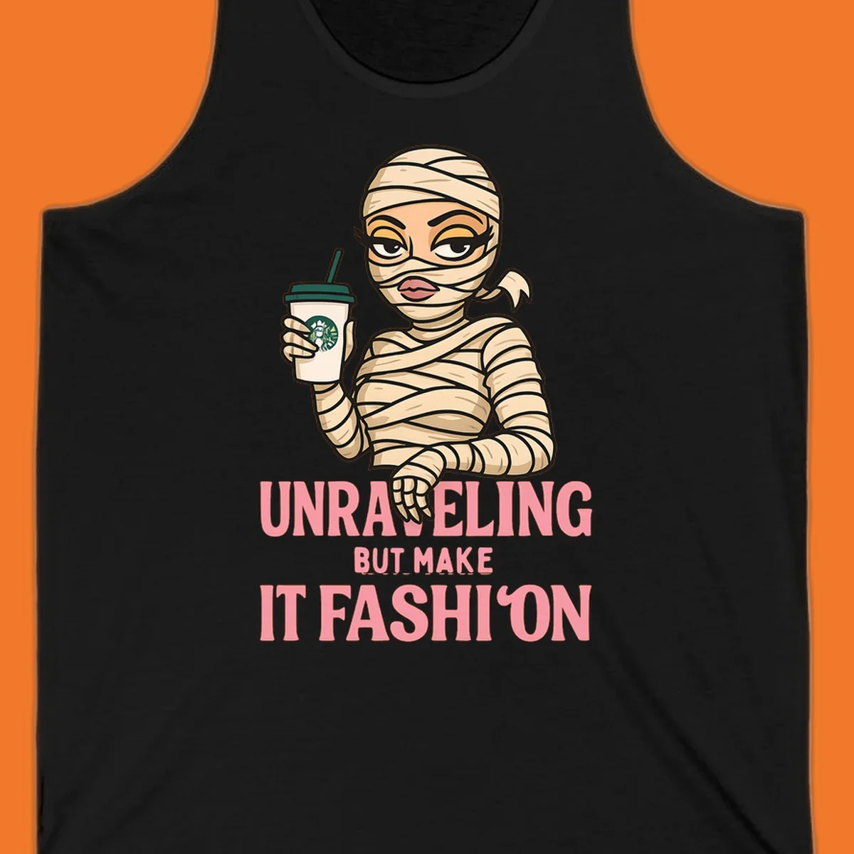 Mummy holding coffee cup with 'Unraveling But Make It Fashion' text. Mummy-fashion-coffee.