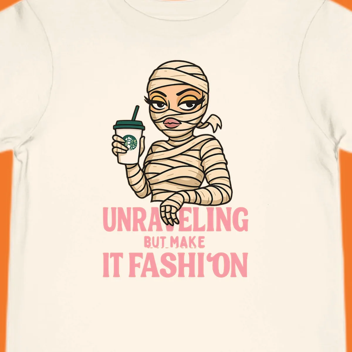 Mummy holding coffee cup with 'Unraveling But Make It Fashion' text. Mummy-fashion-coffee.