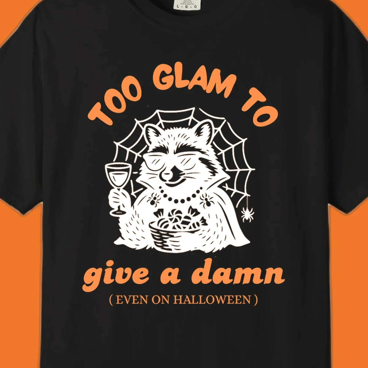 Glam raccoon with sunglasses and wine, 'Too Glam To Give A Damn' text for Halloween.