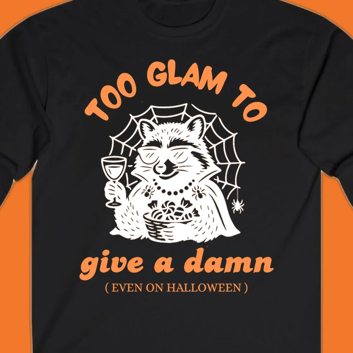 Glam raccoon with sunglasses and wine, 'Too Glam To Give A Damn' text for Halloween.