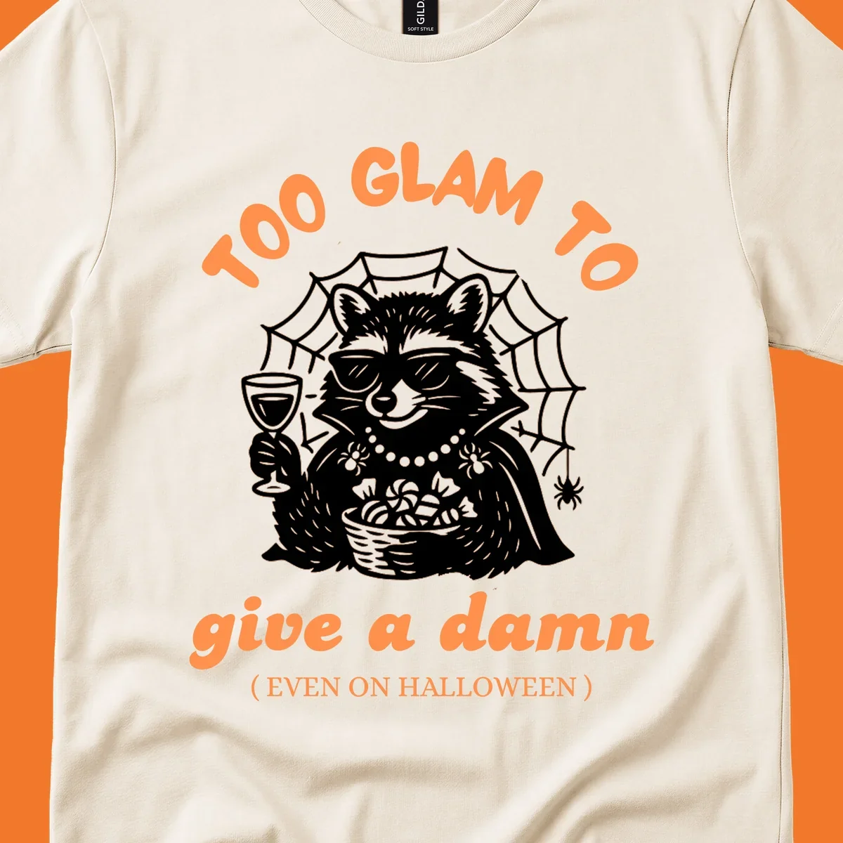 Glam raccoon with sunglasses and wine, 'Too Glam To Give A Damn' text for Halloween.