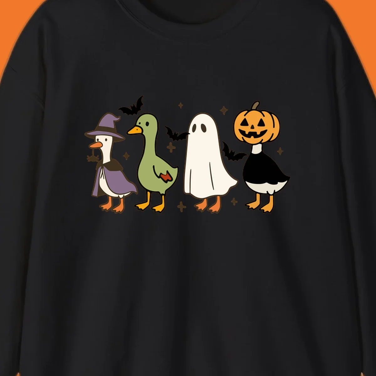Illustration of four cute animals in Halloween costumes: a witch goose, a duckling, a ghost, and a pumpkin goose.