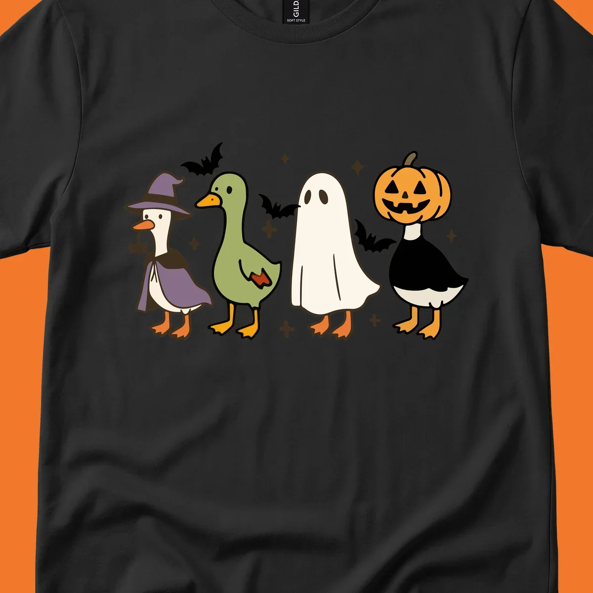 Illustration of four cute animals in Halloween costumes: a witch goose, a duckling, a ghost, and a pumpkin goose.