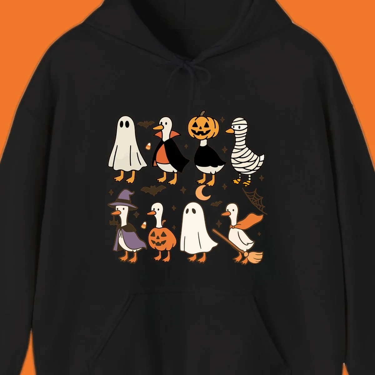 Illustration of cute ducks in various Halloween costumes like ghost, vampire, and pumpkin, on a dark background.