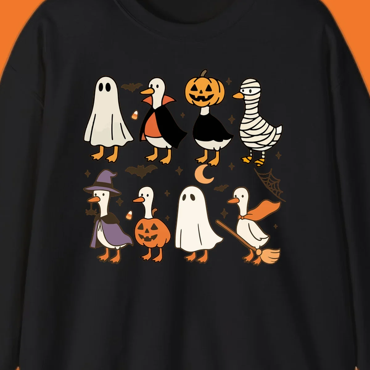 Illustration of cute ducks in various Halloween costumes like ghost, vampire, and pumpkin, on a dark background.