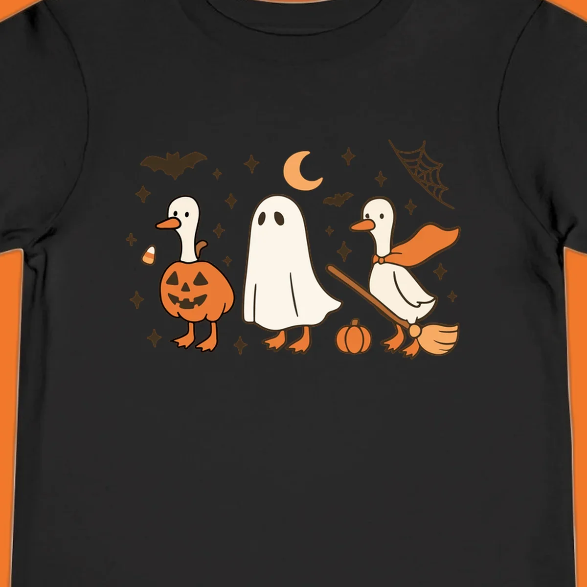 Cute geese in Halloween costumes: pumpkin, ghost, and witch on broom, with bats and stars.