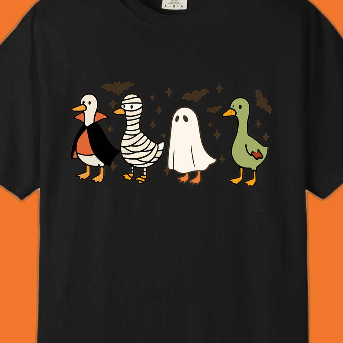 Four cute ducks in Halloween costumes: vampire, mummy, ghost, and plain duck, with bats and stars.