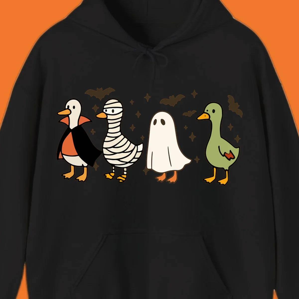 Four cute ducks in Halloween costumes: vampire, mummy, ghost, and plain duck, with bats and stars.