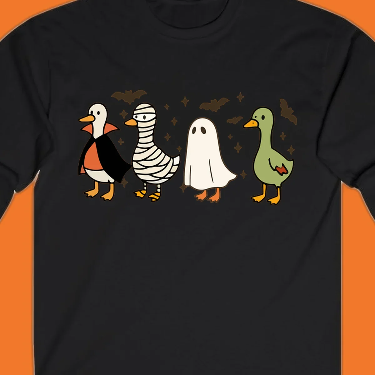 Four cute ducks in Halloween costumes: vampire, mummy, ghost, and plain duck, with bats and stars.