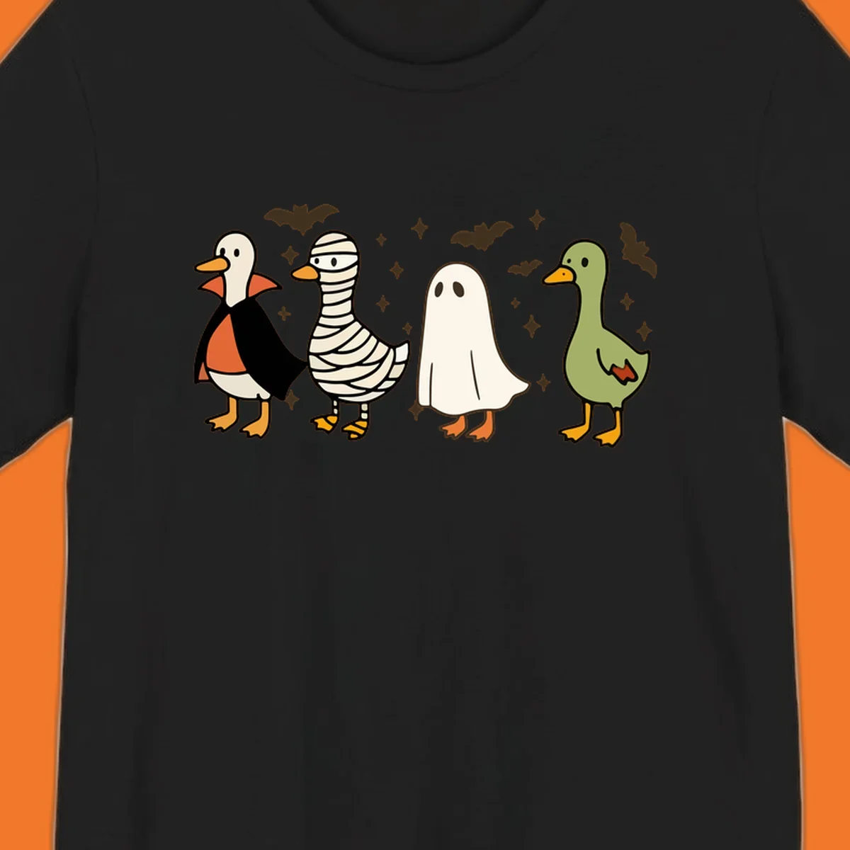 Four cute ducks in Halloween costumes: vampire, mummy, ghost, and plain duck, with bats and stars.