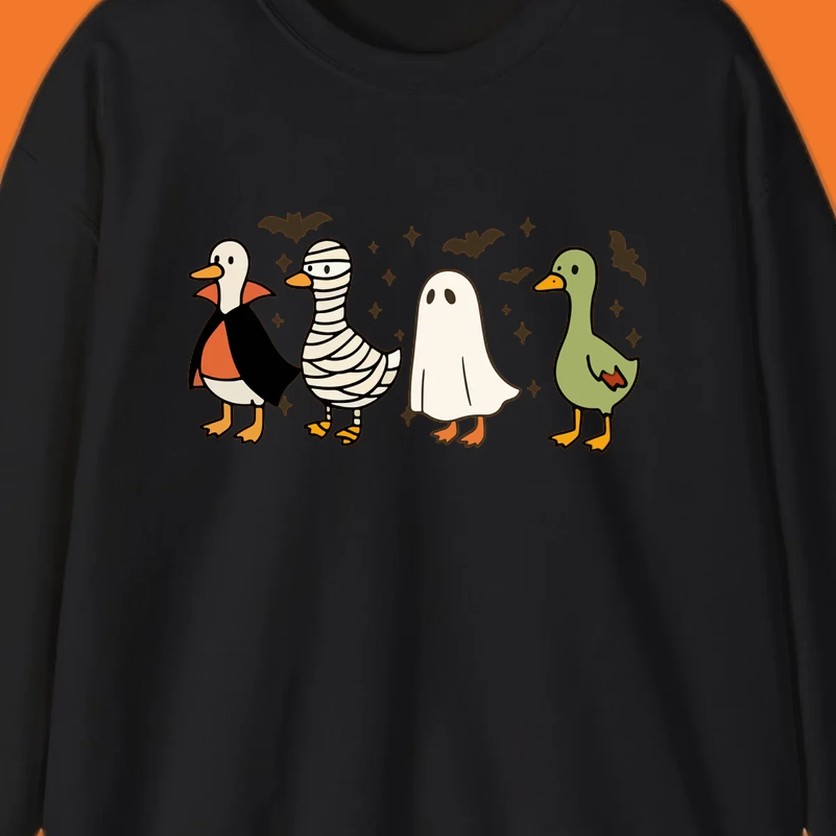 Four cute ducks in Halloween costumes: vampire, mummy, ghost, and plain duck, with bats and stars.