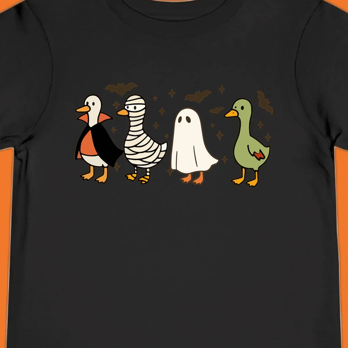 Four cute ducks in Halloween costumes: vampire, mummy, ghost, and plain duck, with bats and stars.